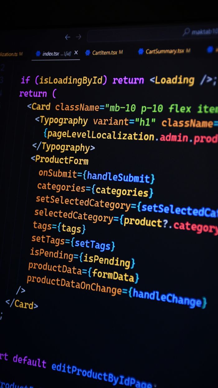 The Art of Drawing Readers In: Your attractive post title goes here Close-up of JSX code on a monitor, showcasing colorful syntax used in ReactJS development.