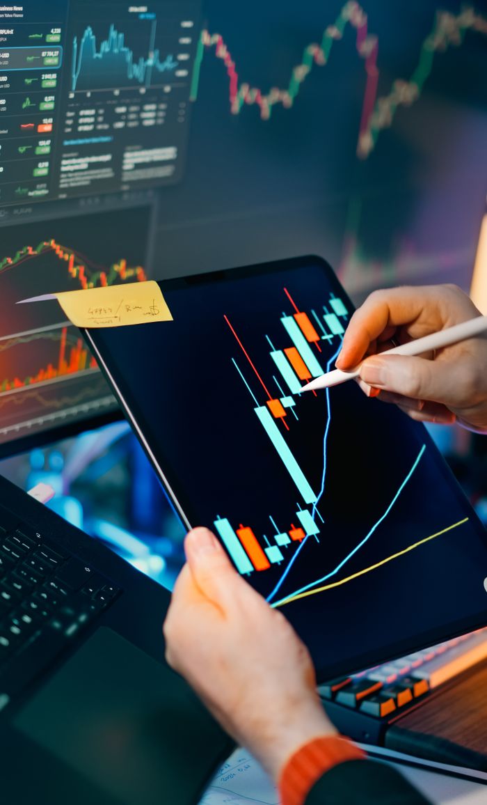 Crafting Captivating Headlines: Your awesome post title goes here Person using a tablet to analyze financial charts for trading insights. Perfect for finance and technology themes.